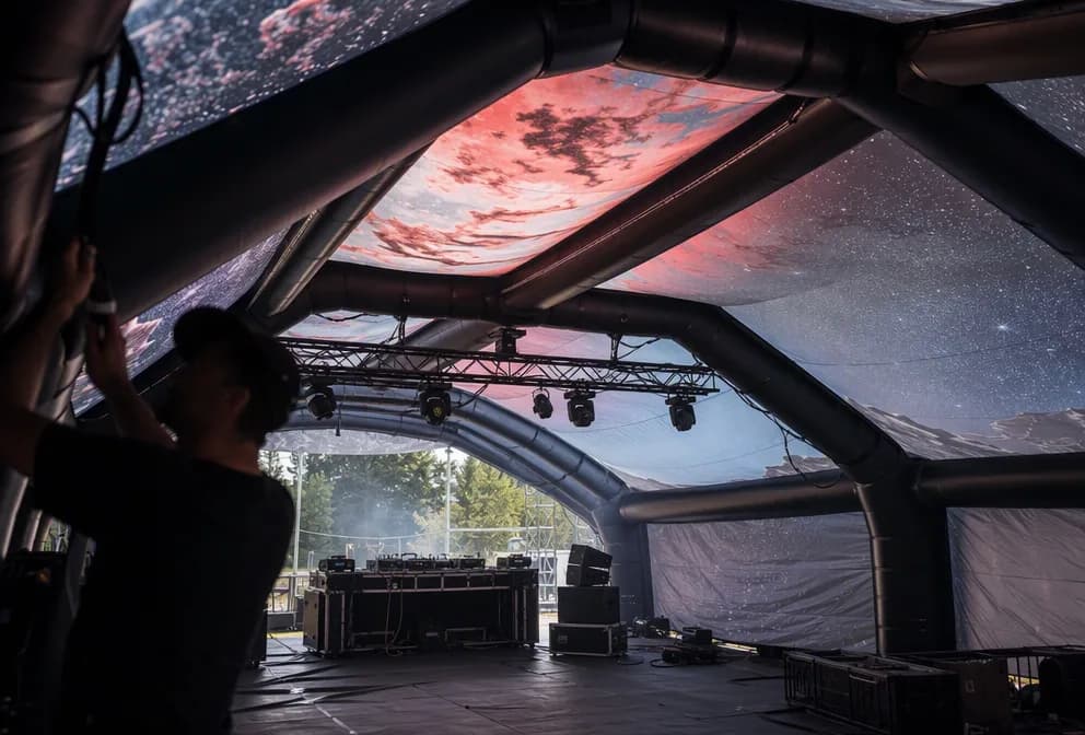 Interior view of a giant inflatable stage tent prepared for an outdoor event