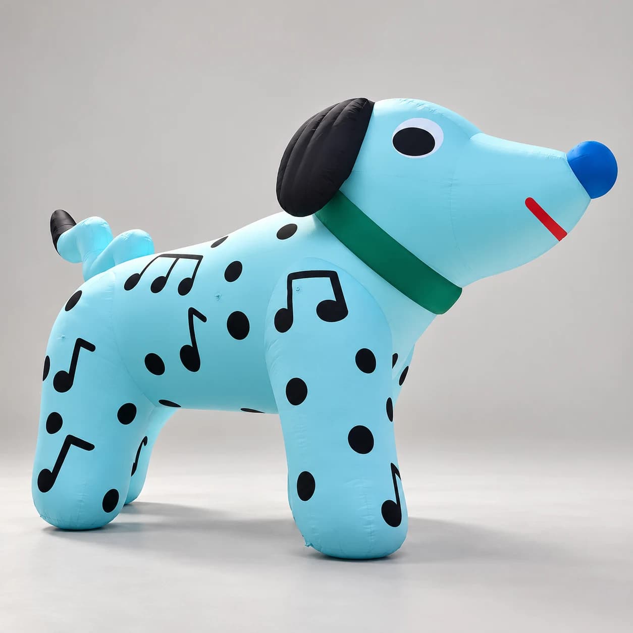 Light blue spotted inflatable dog with musical notes, right-facing studio view