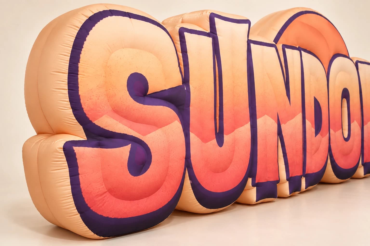 AI-assisted product visualization: Angled close-up of S letter with peach inflatable side depth