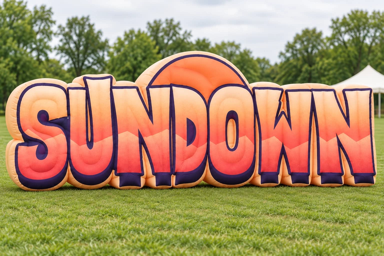 AI-assisted product visualization: SUNDOWN inflatable sign on a lawn in a conceptual event setting