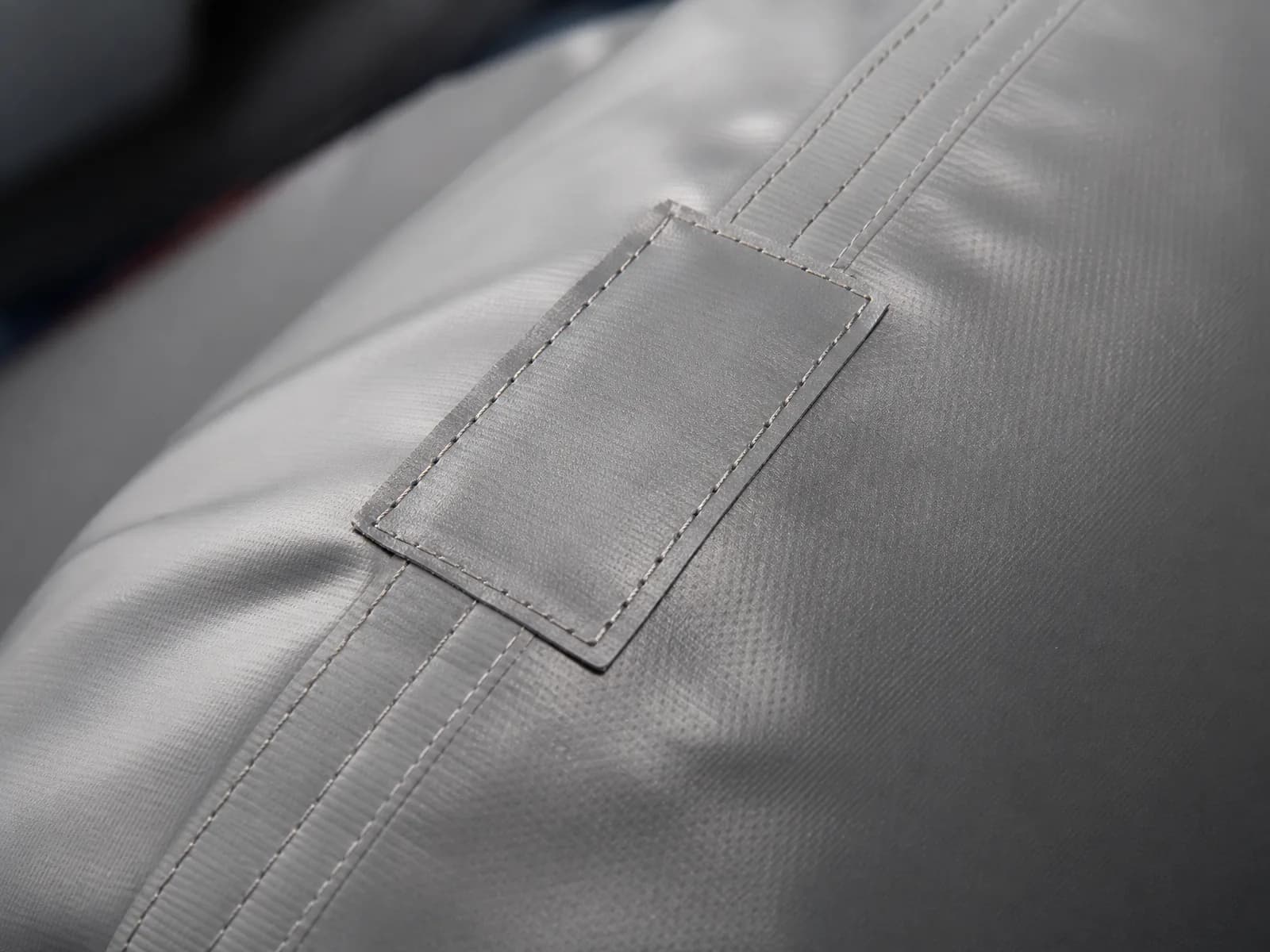 Macro shot of stitching seams and reinforcement patches on inflatable fabric