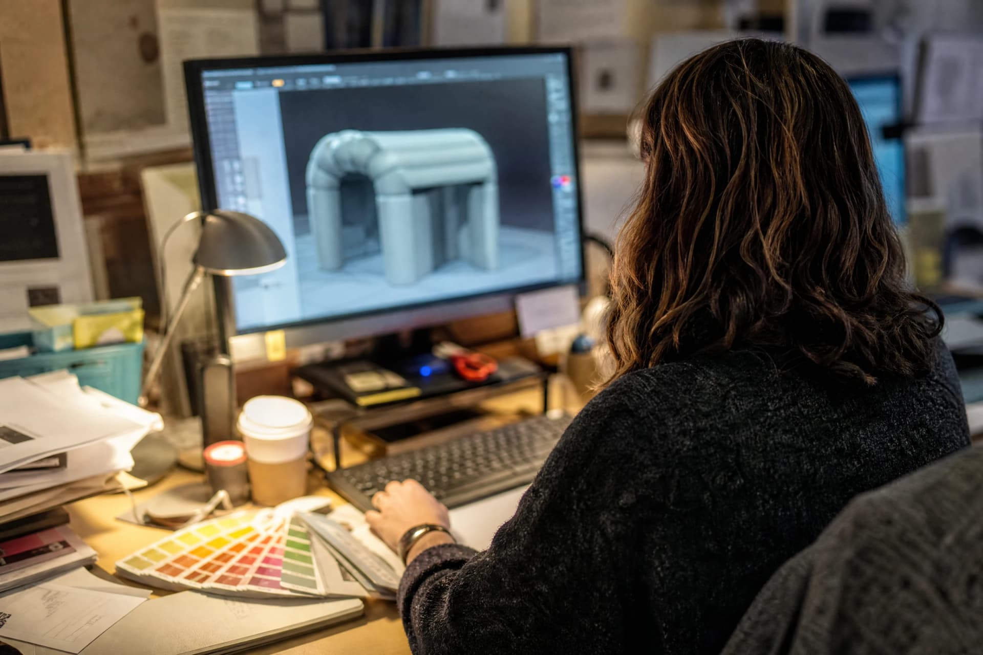 Designer reviewing a 3D inflatable mockup at a production workstation