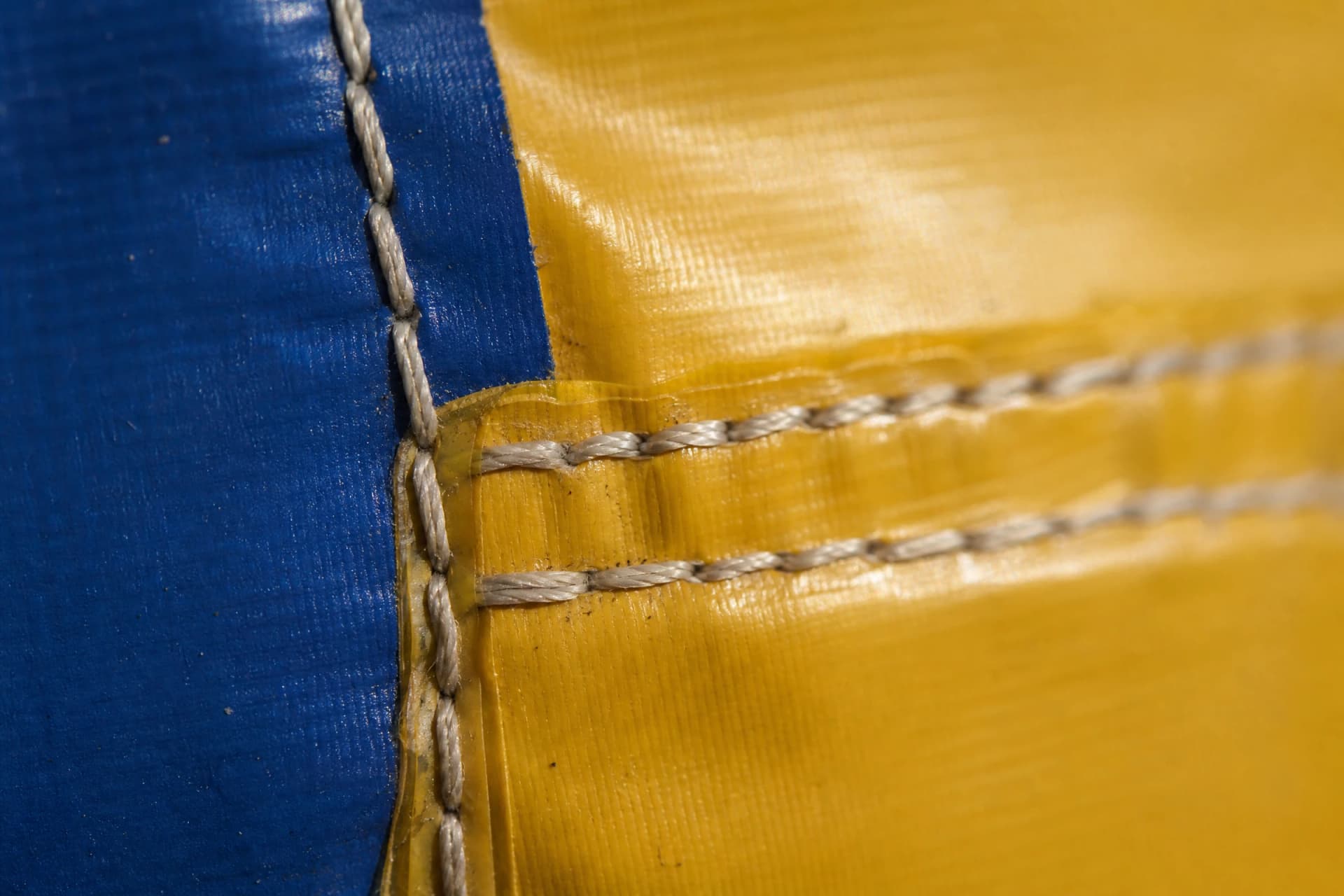 Close view of reinforced stitching and welded seam on inflatable fabric