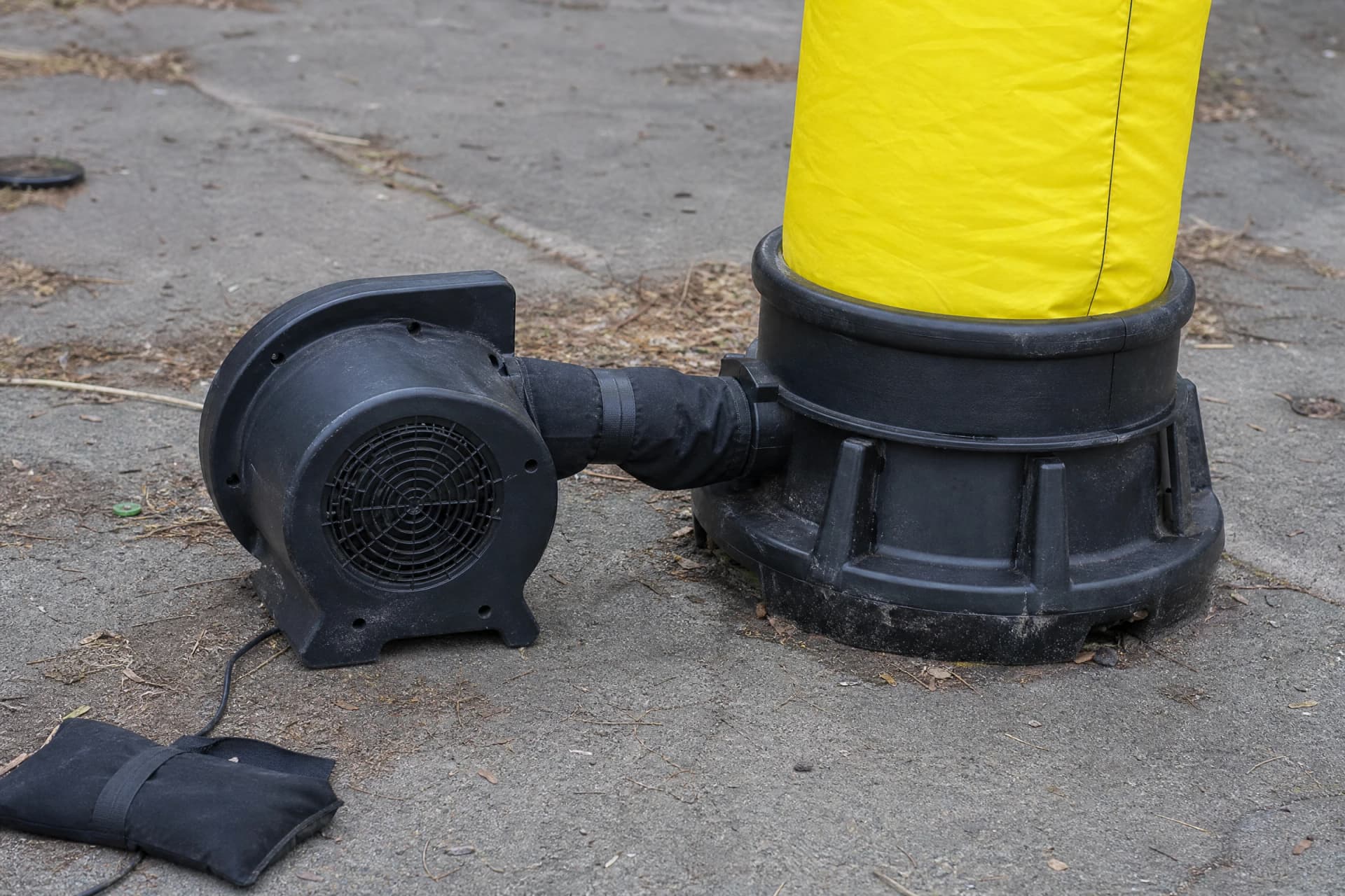 Blower connected to an air dancer with protected cable routing