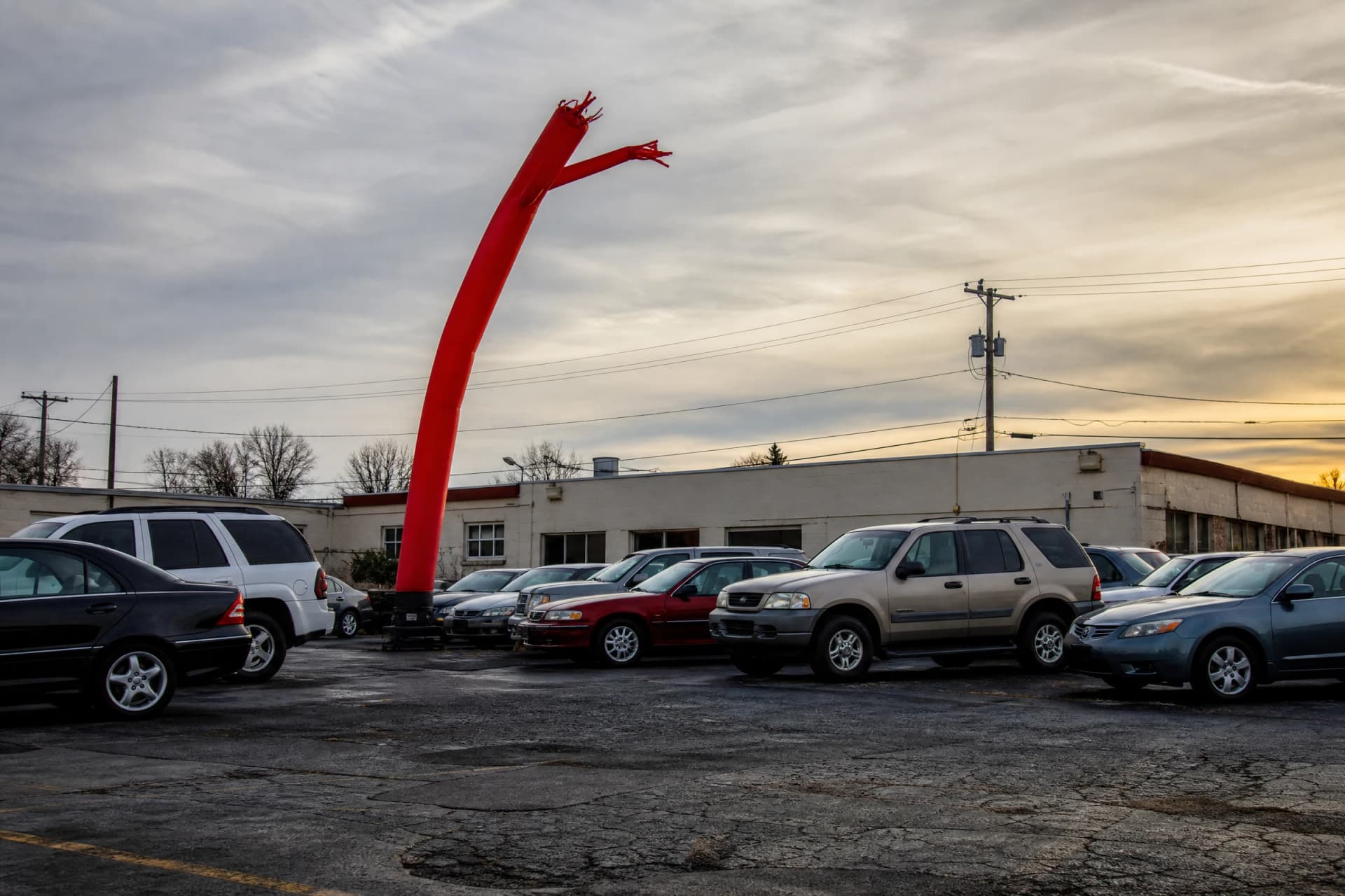 Air dancer tube man positioned outside an automotive dealership