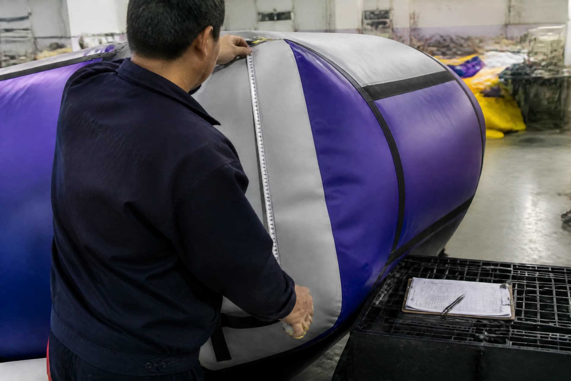 Quality inspector measuring an inflated section during factory review