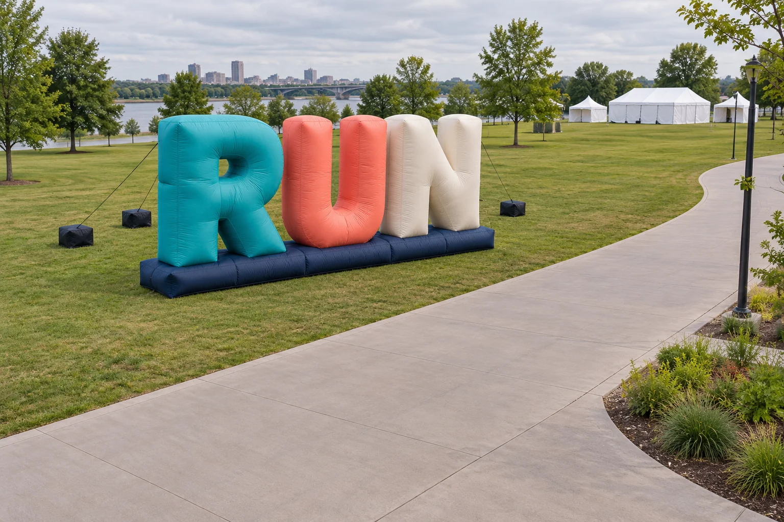 RUN inflatable letters beside an open outdoor event route