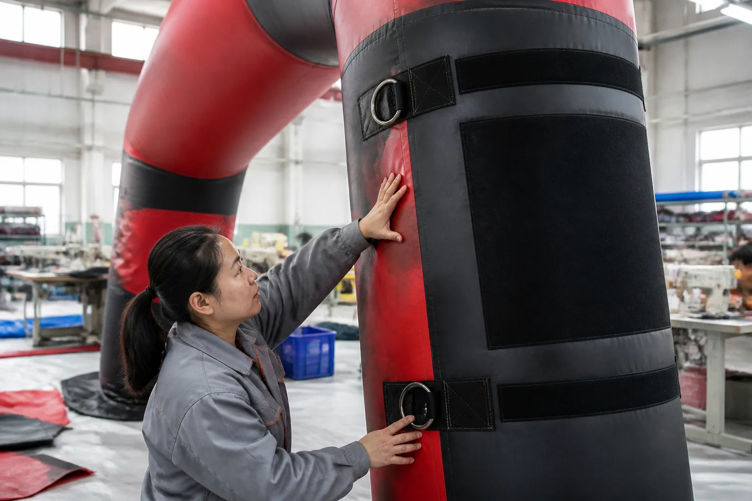 Illustrative factory inspection of attachment hardware and panel placement on an inflatable arch.