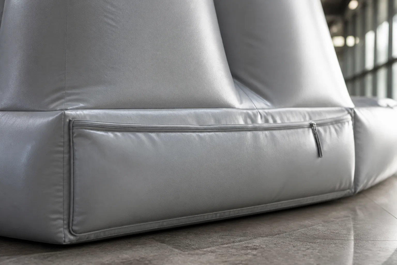 Illustrative close view of a concealed zipper and fabric seam on an indoor inflatable display concept.