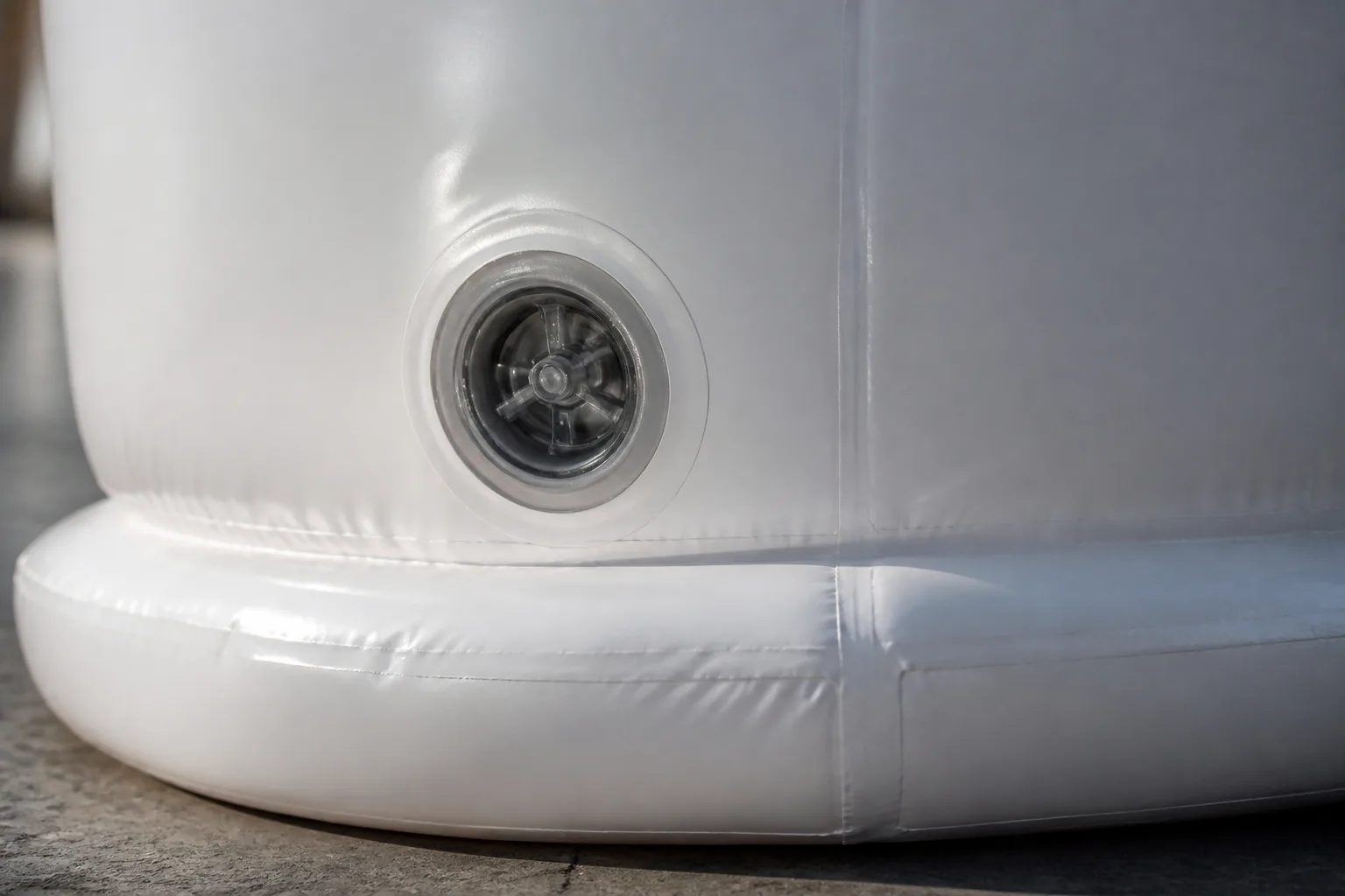 Close product-detail view of a valve and welded seam on an illustrative inflatable form.